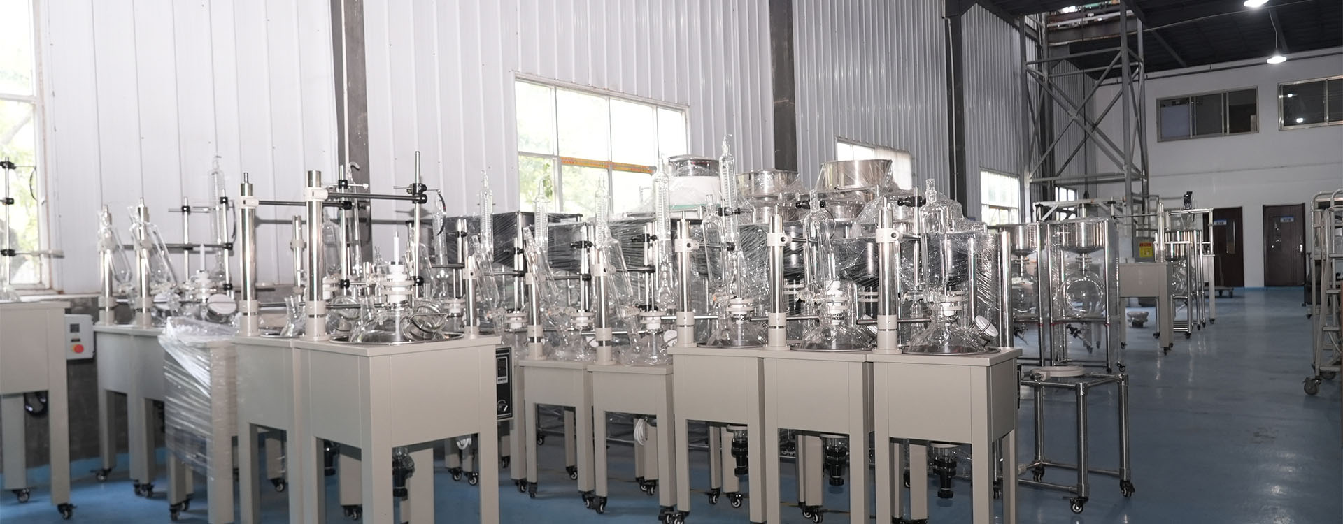 Jacketed glass reactors on frames lined up inside the UnionClay production hall