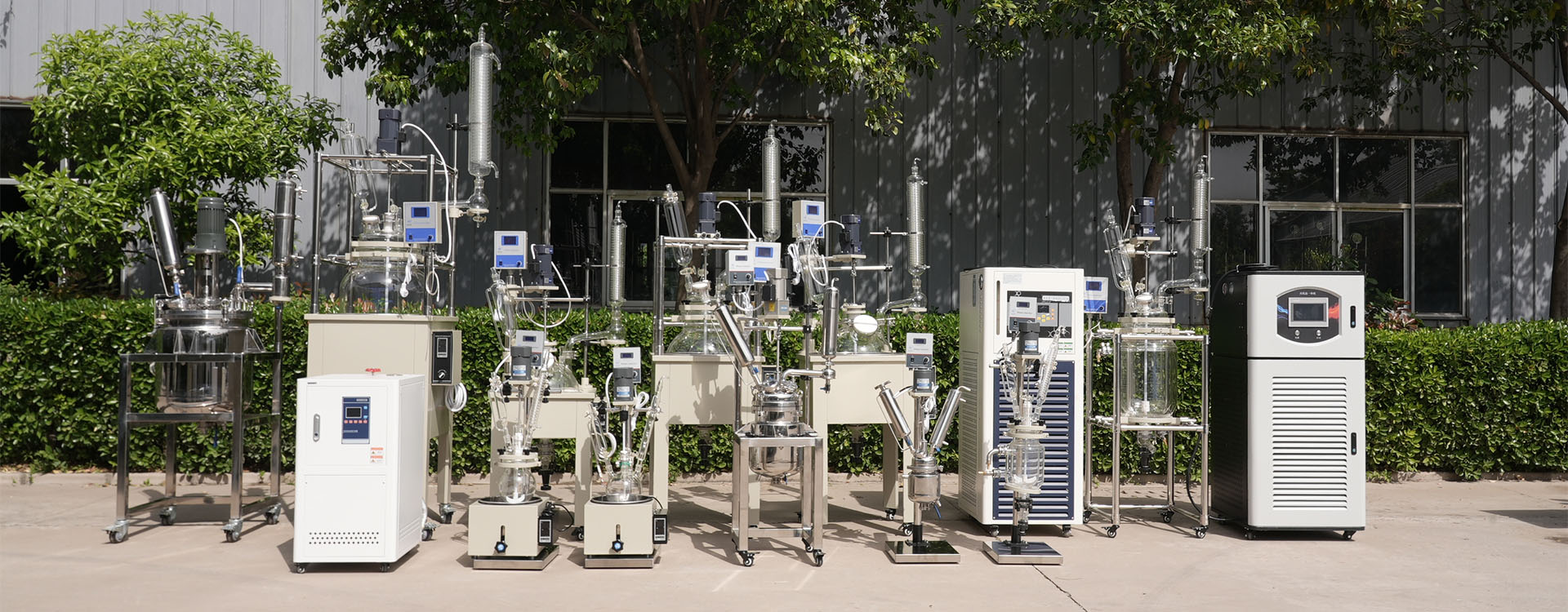 UnionClay equipment lineup outside the factory with reactors, rotary evaporators and recirculating chillers